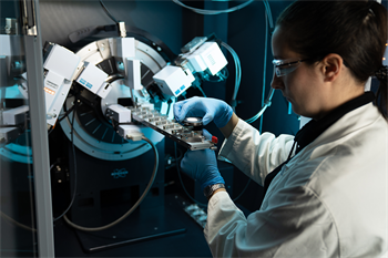 researcher loading samples into diffractometer